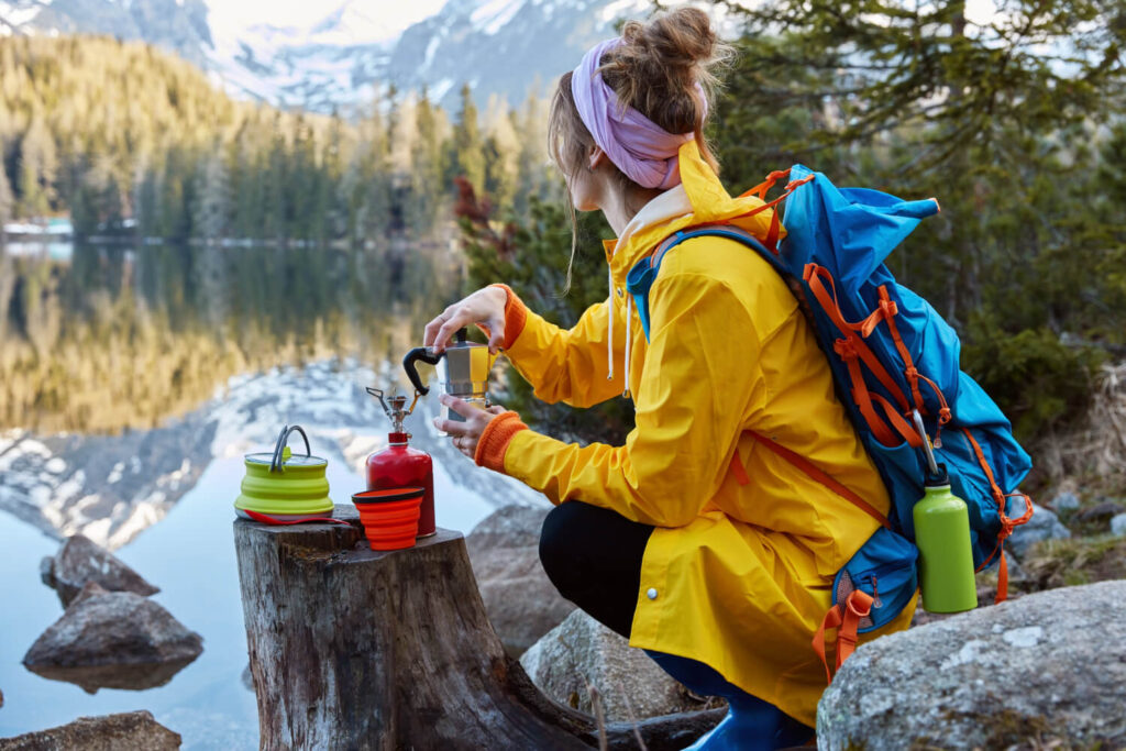 mountaineering woman camping and cooking