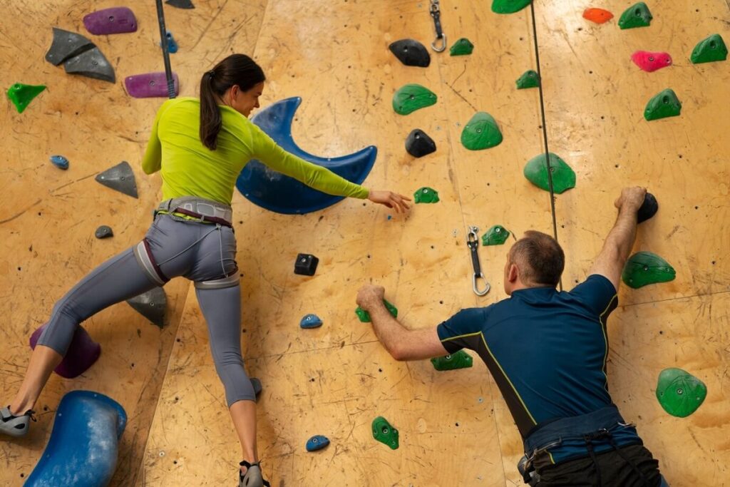 couple rock climbing together indoors arena 23 2150461797 1