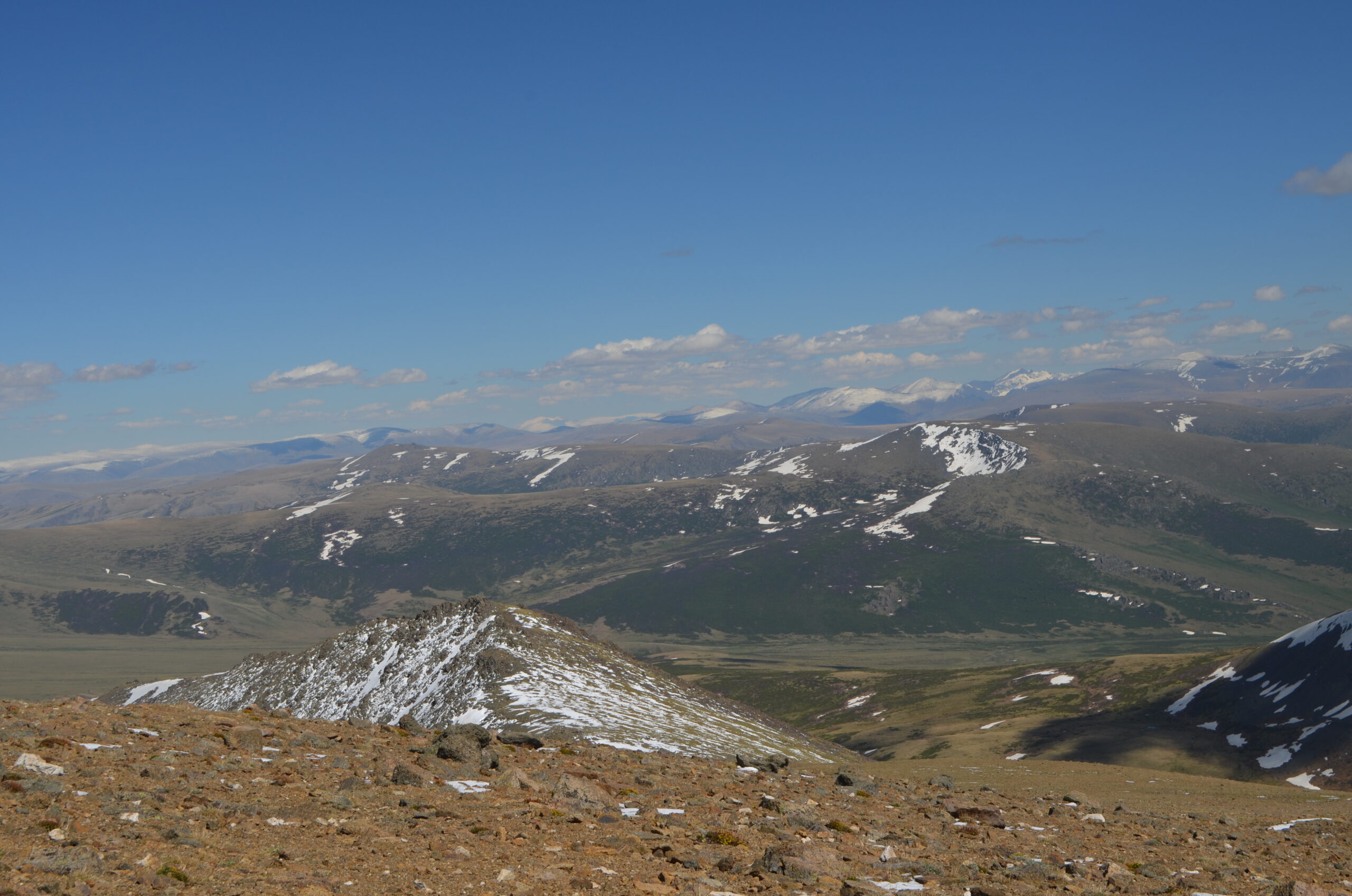 Trekkers descending into the Altai Tavan Bogd Yolt valley at golden hour
