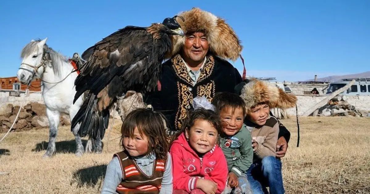 Kazakh eagle-hunter family preparing for a winter hunt with a trained Berkut eagle in Bayan-Ölgii.